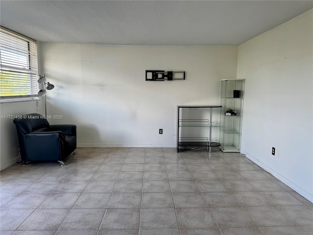 interior space with baseboards and a textured ceiling