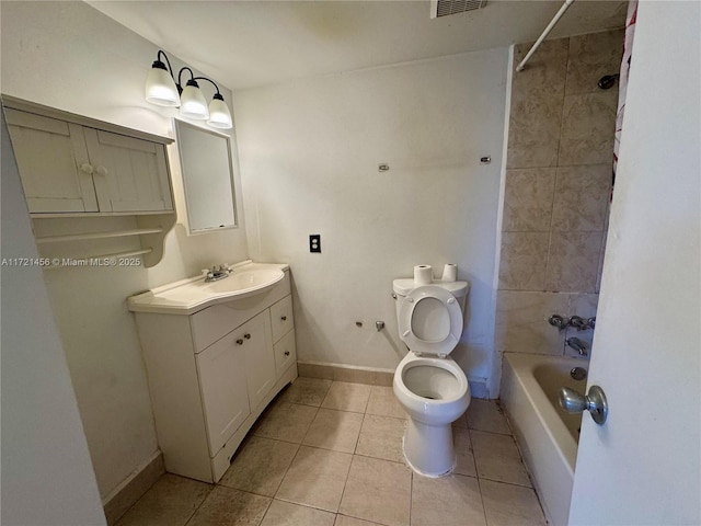 bathroom with bathtub / shower combination, toilet, vanity, baseboards, and tile patterned floors