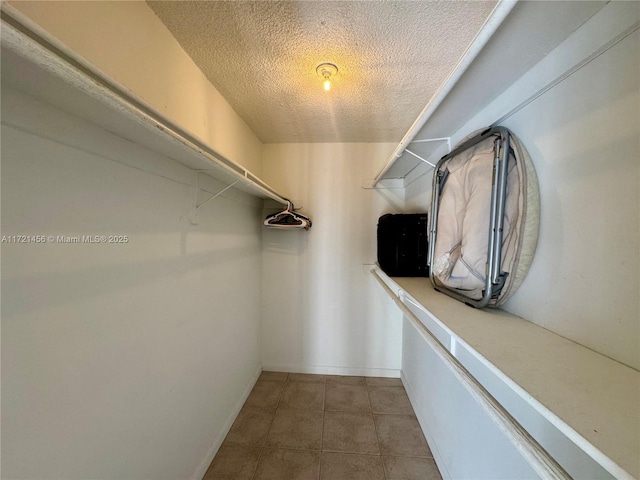 walk in closet featuring tile patterned floors