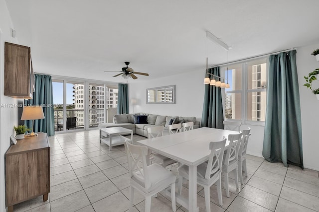 dining room featuring floor to ceiling windows, ceiling fan, and light tile patterned flooring