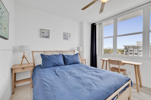 bedroom with ceiling fan and light tile patterned floors