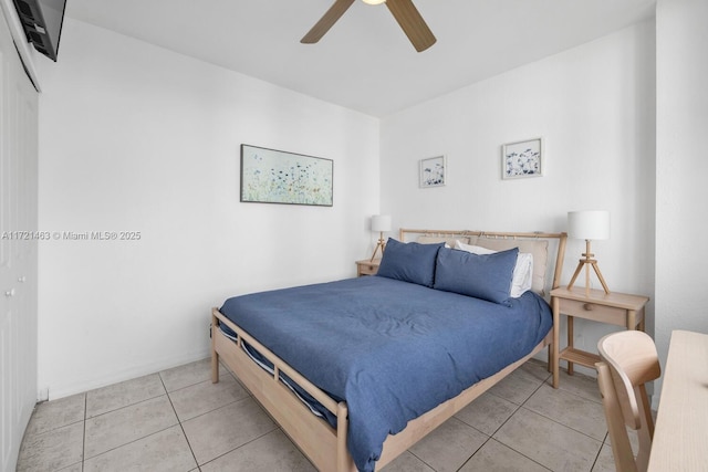 tiled bedroom featuring ceiling fan and a closet