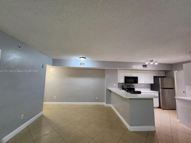 kitchen featuring a textured ceiling, light tile patterned floors, appliances with stainless steel finishes, kitchen peninsula, and white cabinets