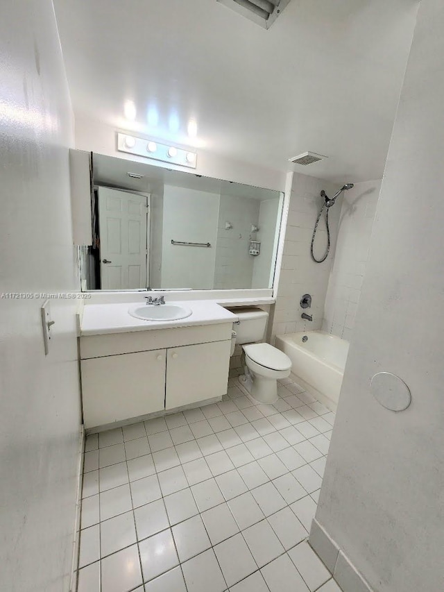 full bathroom with vanity, tile patterned floors, toilet, and tiled shower / bath