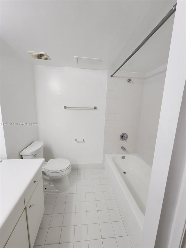 full bathroom featuring vanity, tiled shower / bath, tile patterned floors, and toilet