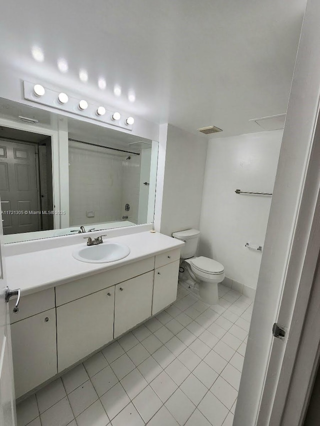 bathroom with tile patterned flooring, vanity, and toilet