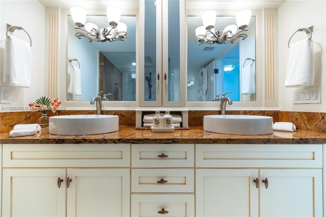 bathroom with vanity and a notable chandelier