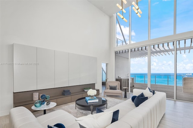 living room with a towering ceiling and a water view