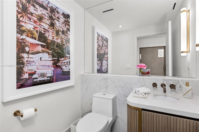 bathroom with radiator heating unit, vanity, tile walls, and toilet