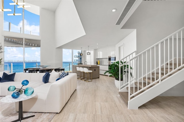 living room featuring a water view and sink