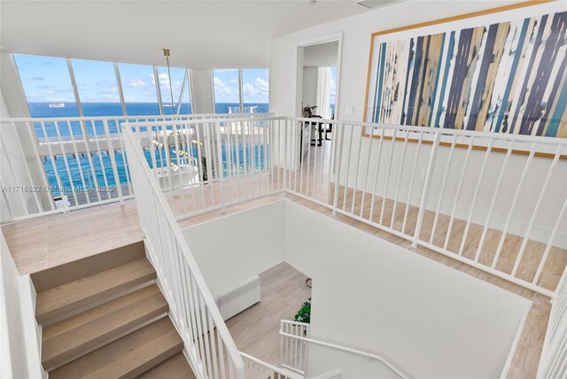 stairway featuring hardwood / wood-style floors and a water view