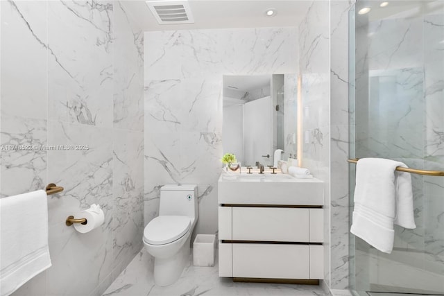 bathroom with vanity, toilet, and a shower with shower door