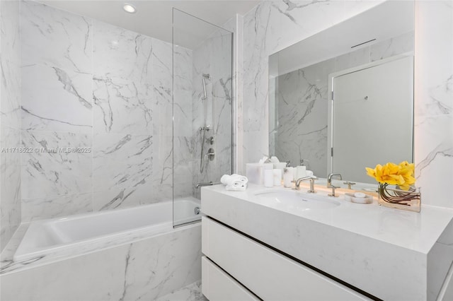 bathroom featuring vanity and tiled shower / bath combo