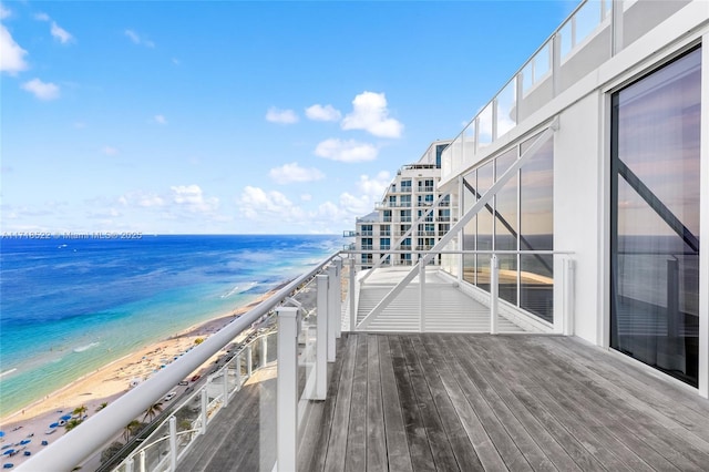 balcony with a water view and a beach view