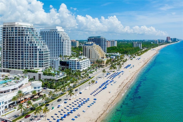 drone / aerial view featuring a water view and a view of the beach