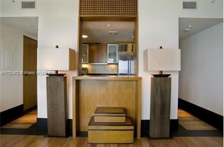 kitchen with hardwood / wood-style flooring and fridge