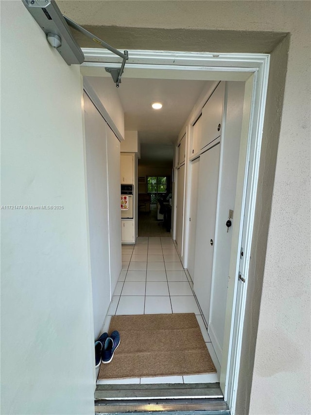 hallway featuring light tile patterned floors