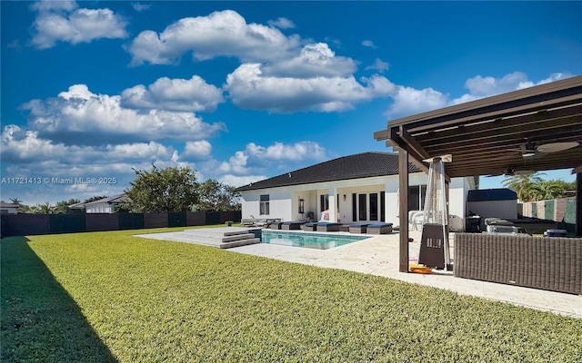 view of swimming pool featuring a yard, a patio, an outdoor hangout area, and ceiling fan