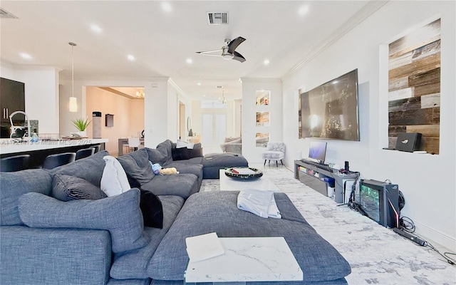 living room with ceiling fan and ornamental molding