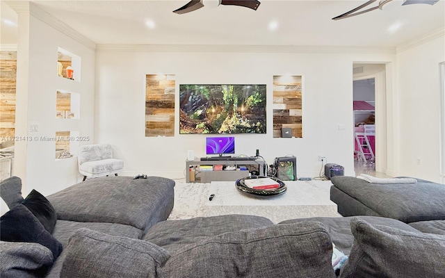 living room with ceiling fan and ornamental molding