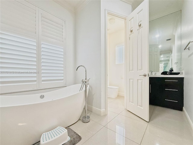 bathroom with tile patterned flooring, vanity, toilet, and a tub