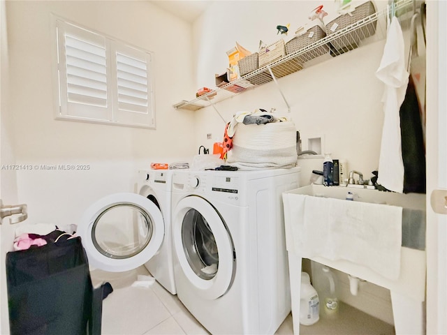 clothes washing area featuring separate washer and dryer and light tile patterned floors