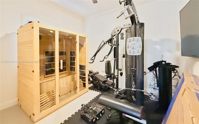 workout room featuring ornamental molding