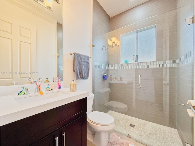 bathroom featuring vanity, toilet, walk in shower, and crown molding