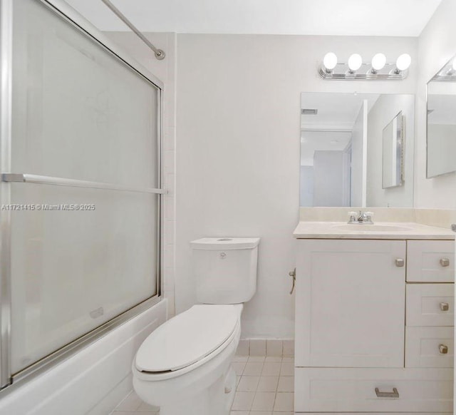 full bathroom with tile patterned flooring, vanity, toilet, and enclosed tub / shower combo