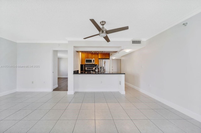 unfurnished living room with a textured ceiling, ceiling fan, light tile patterned floors, and crown molding