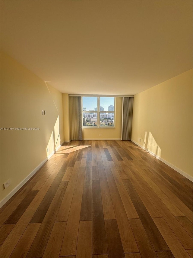 unfurnished room with hardwood / wood-style floors