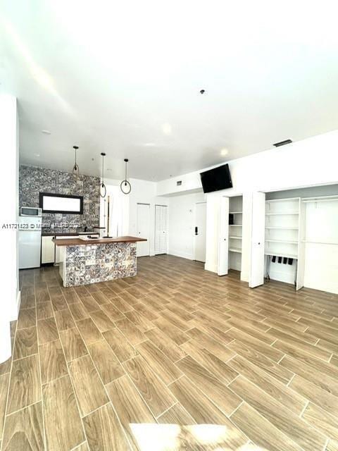 kitchen with white cabinets, hardwood / wood-style floors, and backsplash