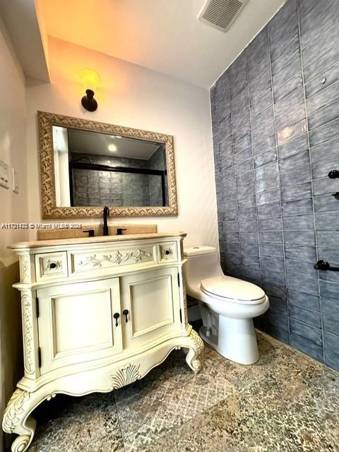 bathroom featuring vanity and toilet