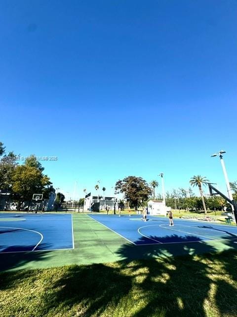 view of basketball court with a lawn