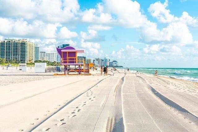 view of street featuring a beach view and a water view