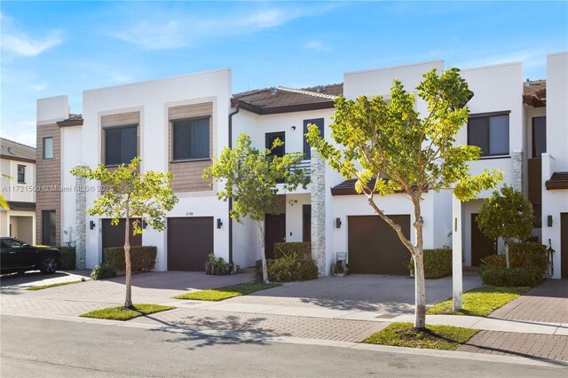 view of front of home featuring a balcony and a garage