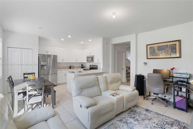 living area with recessed lighting, light tile patterned flooring, and stairs