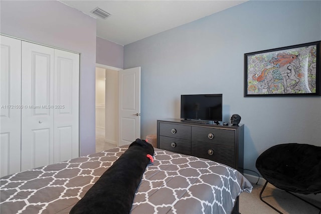 carpeted bedroom featuring a closet and visible vents