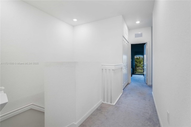 hall with carpet floors, visible vents, and recessed lighting