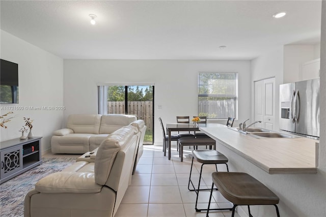 living area with light tile patterned floors, recessed lighting, and a healthy amount of sunlight