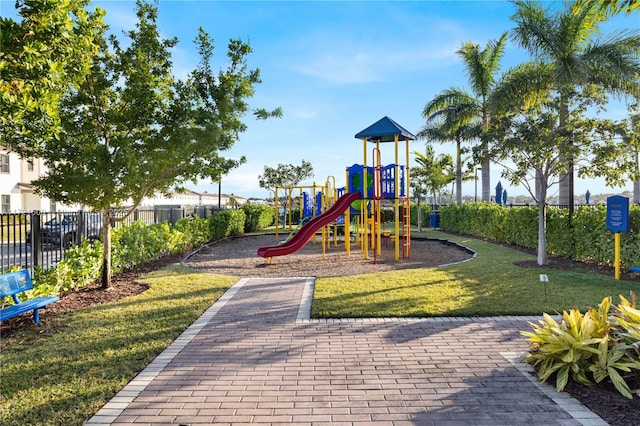 communal playground with a lawn and fence