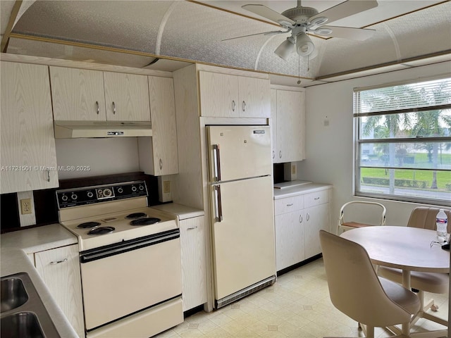 kitchen featuring ceiling fan, white appliances, and sink