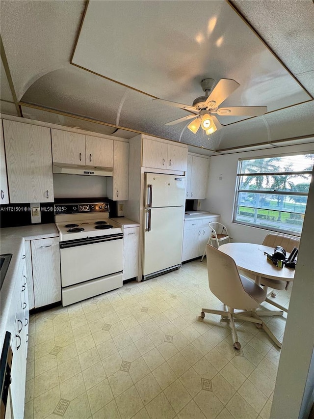 kitchen featuring ceiling fan, white appliances, and a textured ceiling