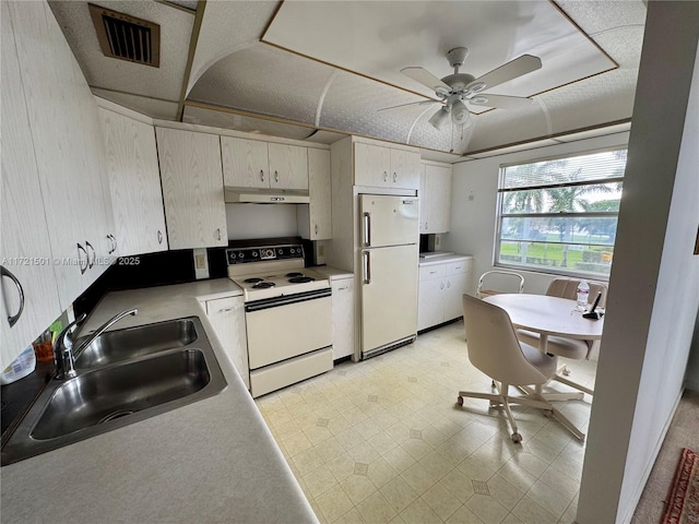 kitchen featuring white appliances, ceiling fan, and sink