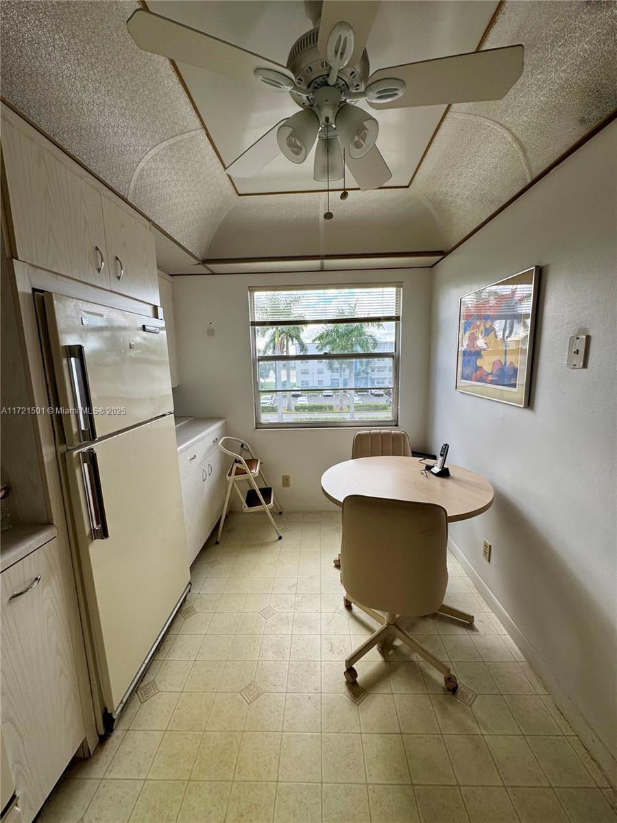 interior space featuring ceiling fan and vaulted ceiling