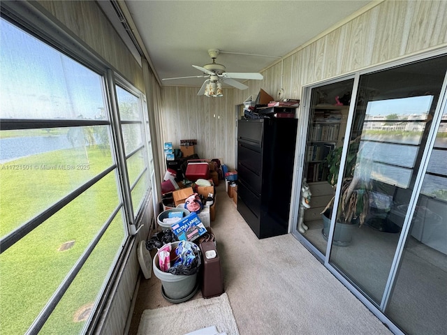 sunroom / solarium featuring ceiling fan