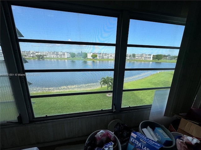 sunroom / solarium with plenty of natural light and a water view