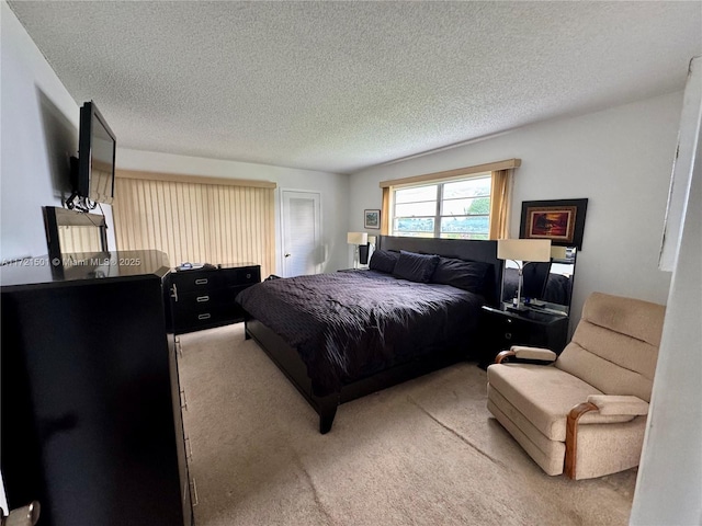 carpeted bedroom featuring a textured ceiling