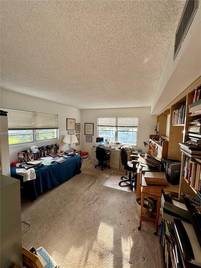 carpeted bedroom featuring a textured ceiling