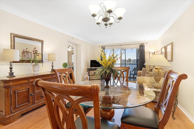 dining space with a chandelier, light hardwood / wood-style floors, a textured ceiling, and ornamental molding